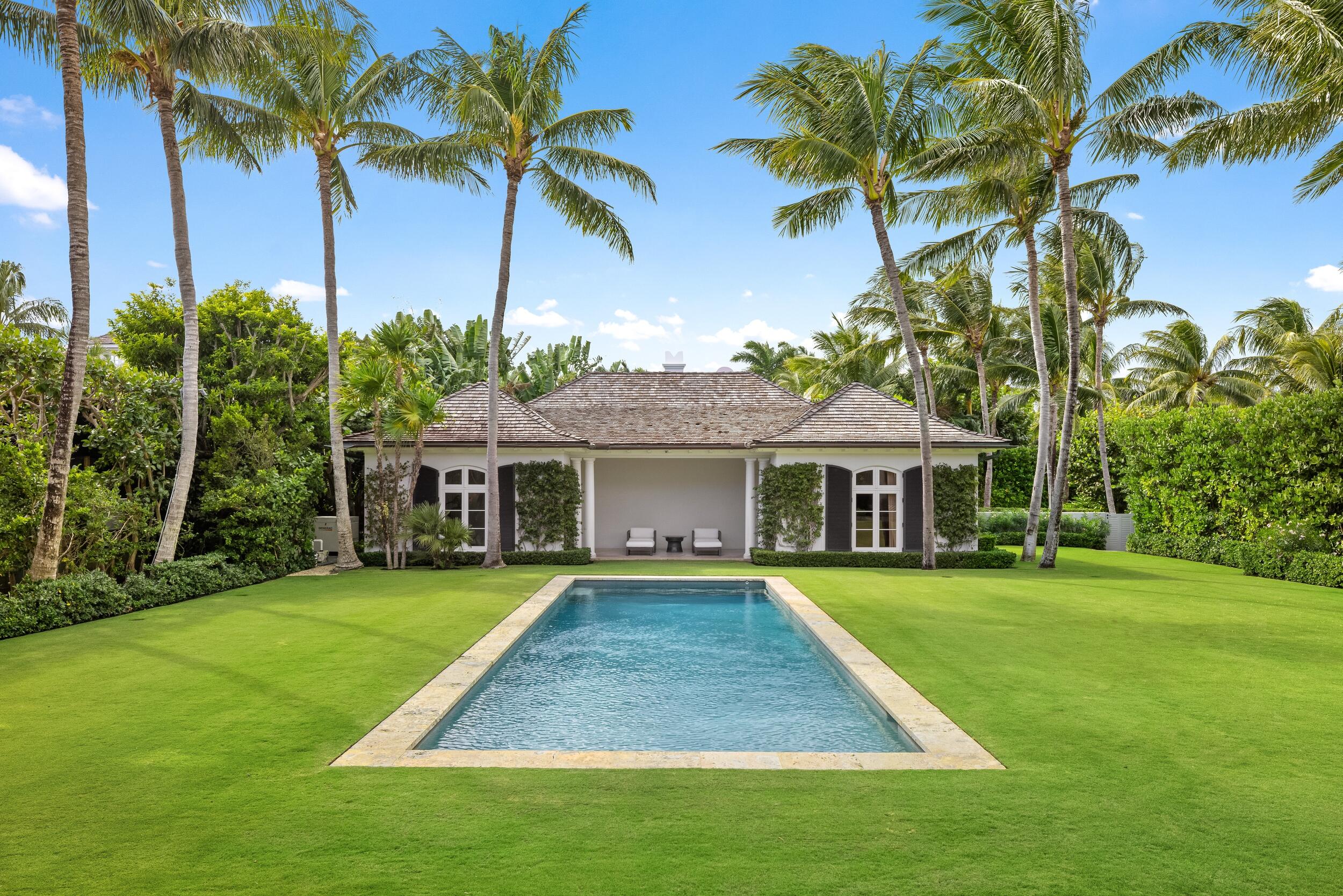 102 Reef Road Palm Beach, FL 33480 - Photo 18 of 22 a view of a house with a big yard and palm trees
