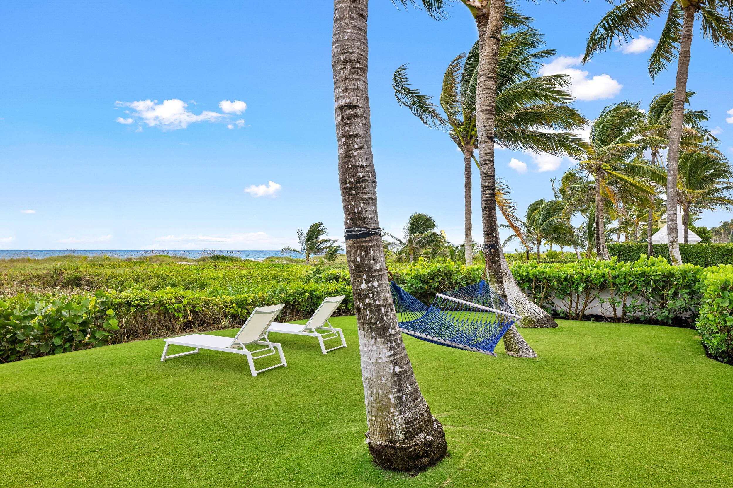 102 Reef Road Palm Beach, FL 33480 - Photo 21 of 22 a view of a chair and table in the garden