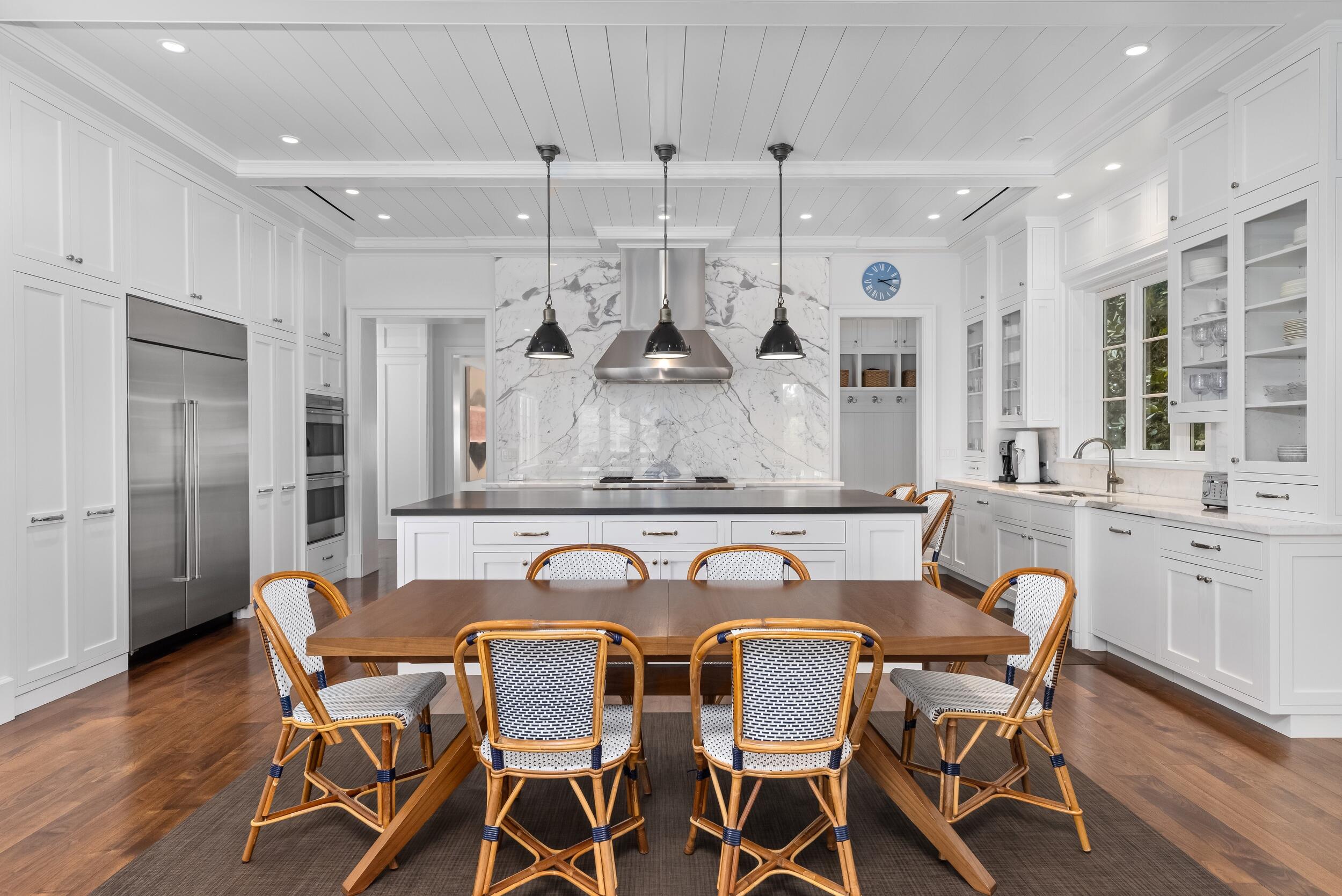102 Reef Road Palm Beach, FL 33480 - Photo 9 of 22 a view of a dining room with furniture a kitchen and chandelier