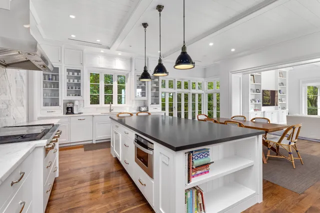 a kitchen with stainless steel appliances granite countertop a stove and a wooden floors
