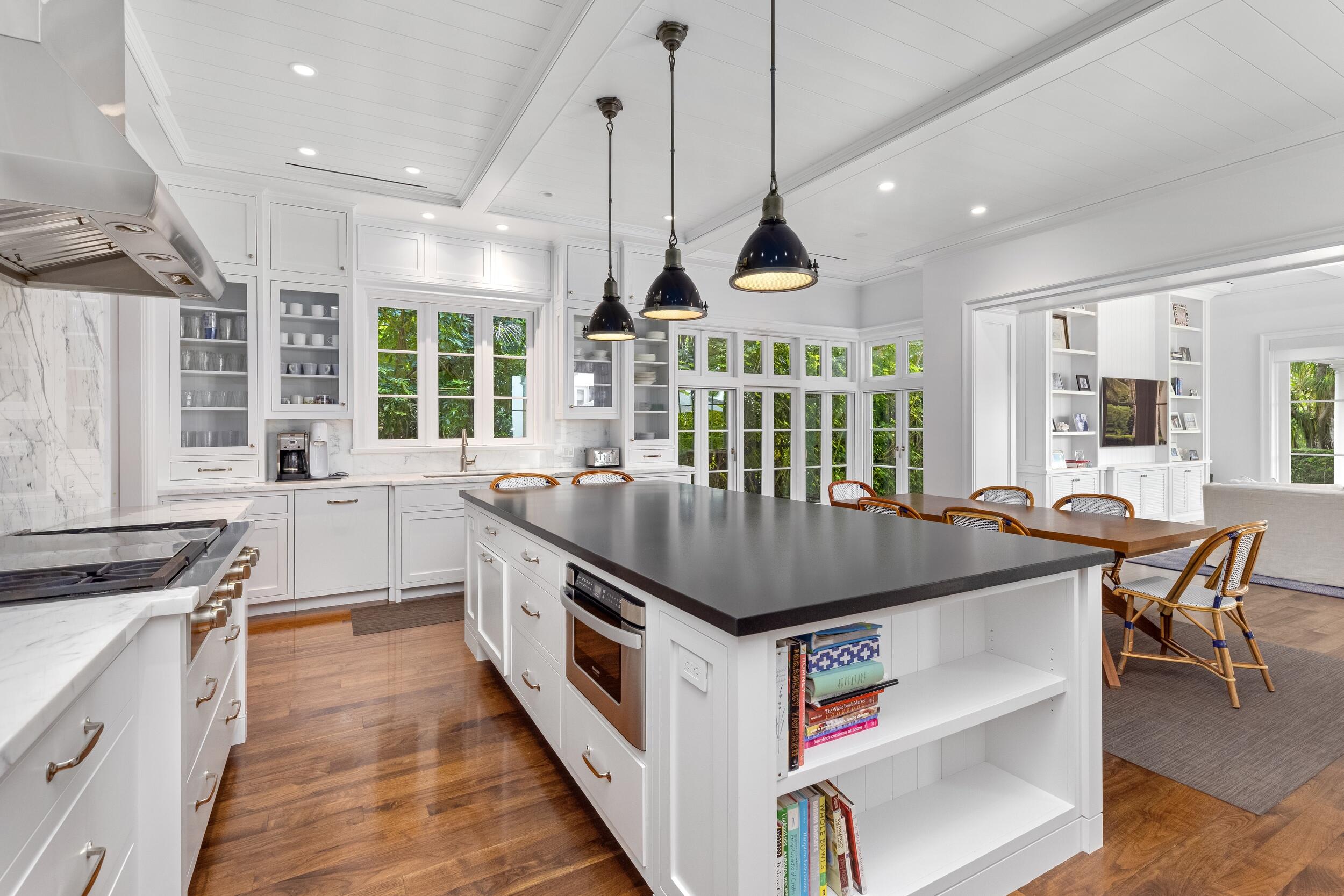 102 Reef Road Palm Beach, FL 33480 - Photo 10 of 22 a kitchen with stainless steel appliances granite countertop a stove and a wooden floors