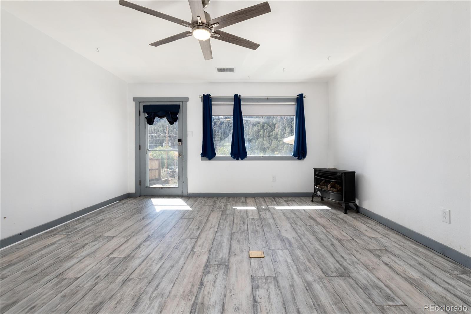 735 Colorado Boulevard Idaho Springs, CO 80452 - Photo 15 of 34 wooden floor in an empty room with a window