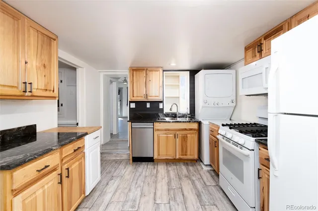 a kitchen with a stove top oven and refrigerator