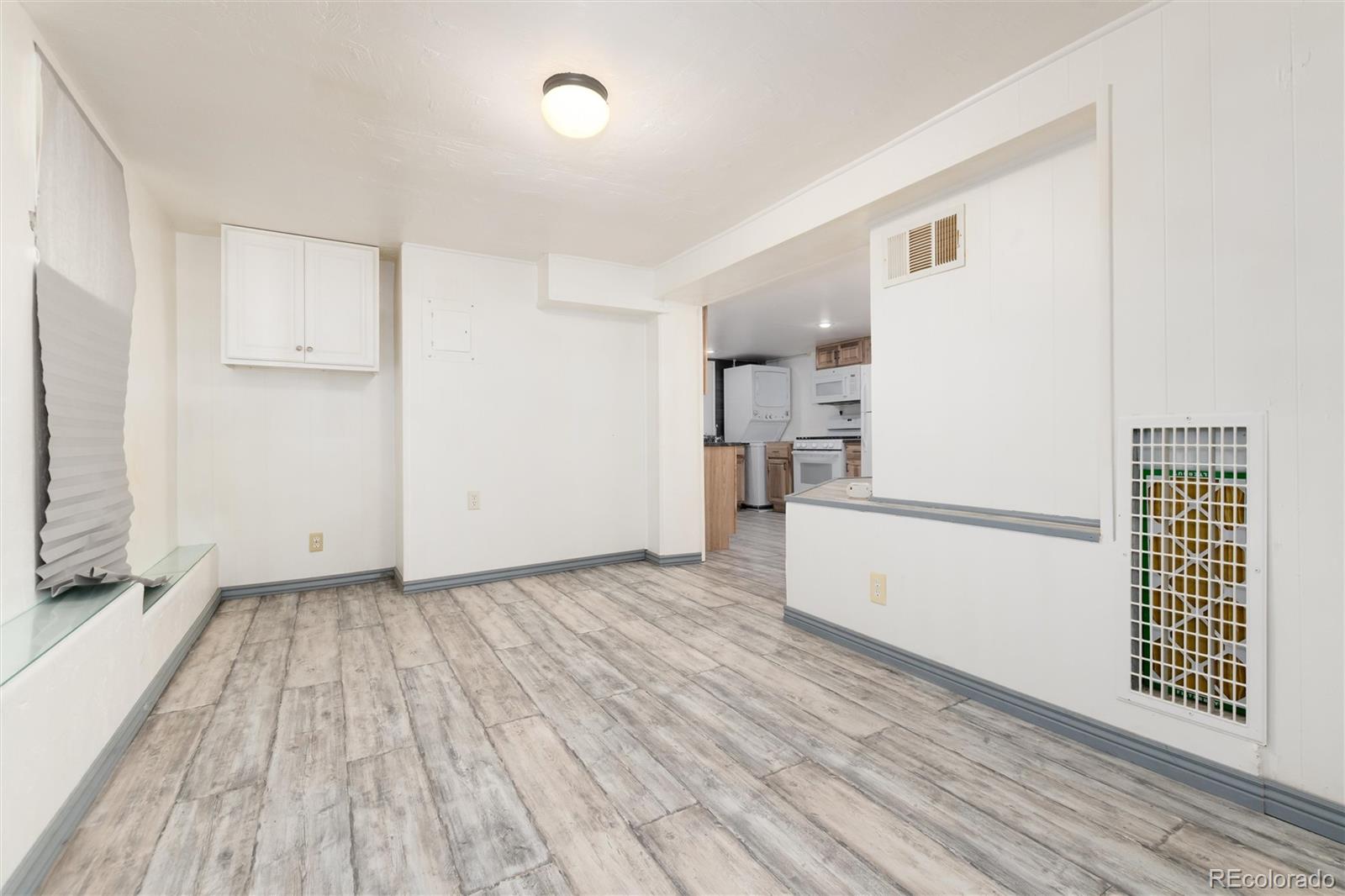 735 Colorado Boulevard Idaho Springs, CO 80452 - Photo 23 of 34 a view of a kitchen with wooden floor and electronic appliances