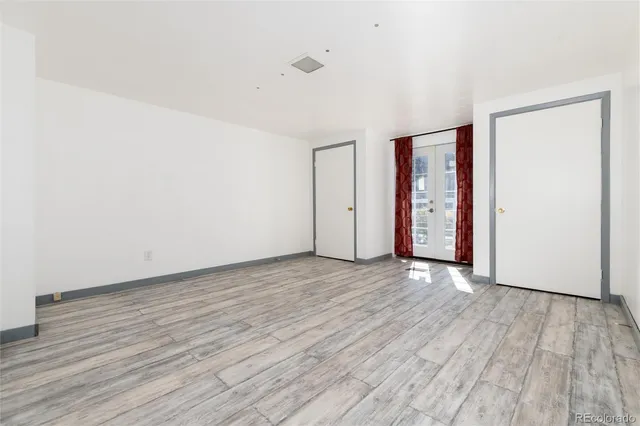 a view of a room with wooden floor
