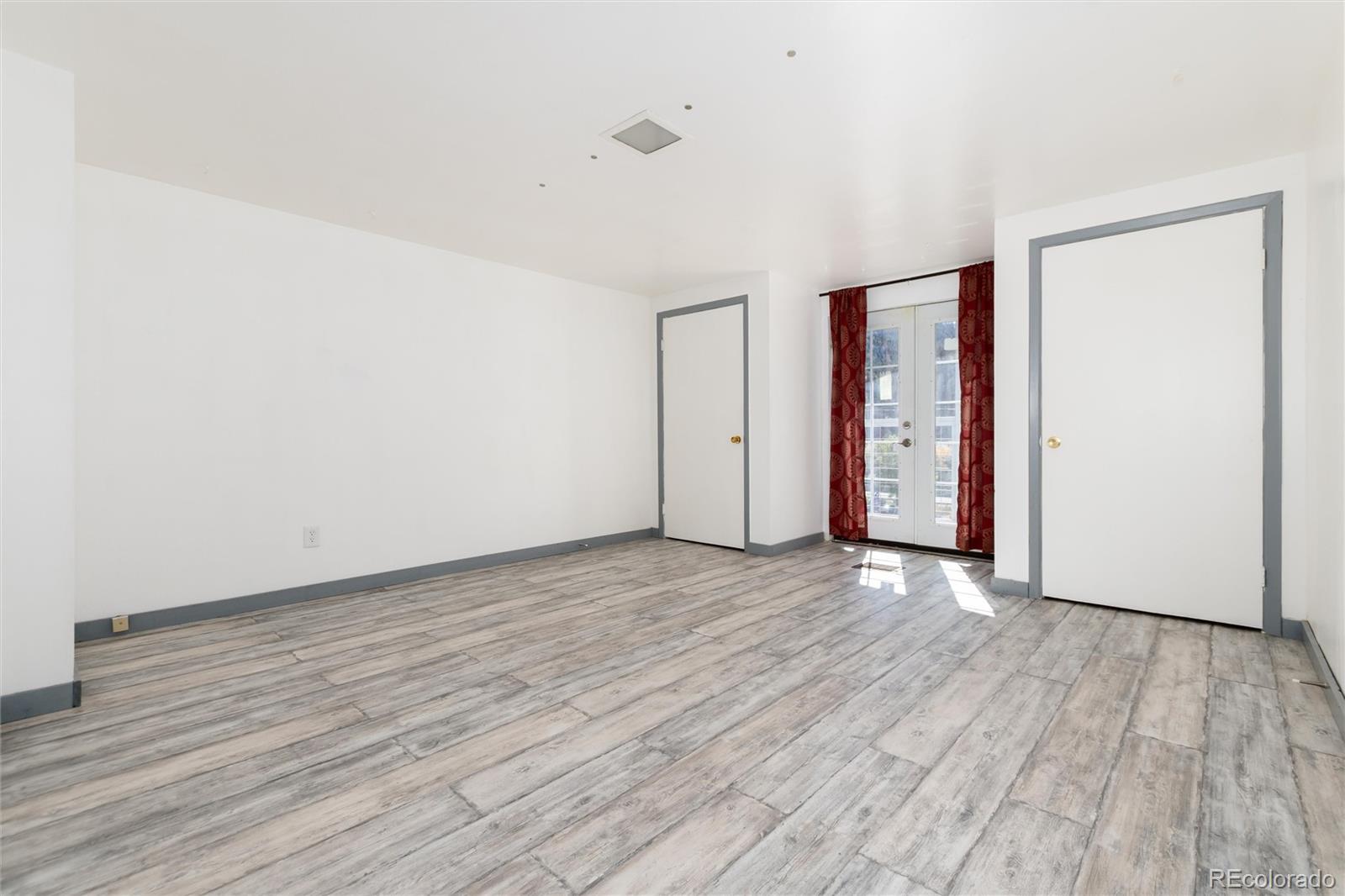 735 Colorado Boulevard Idaho Springs, CO 80452 - Photo 24 of 34 a view of an empty room with wooden floor and closet