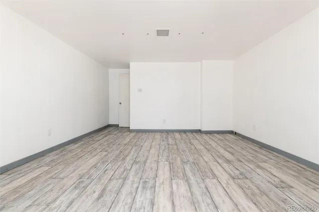 a view of a room with wooden floor