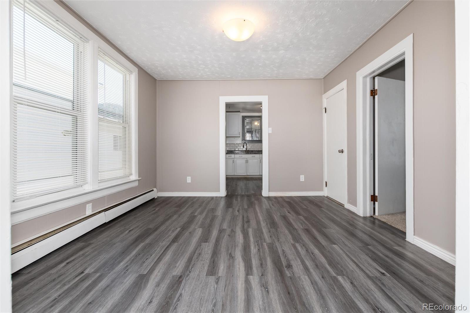 735 Colorado Boulevard Idaho Springs, CO 80452 - Photo 3 of 34 a view of empty room with wooden floor and fan