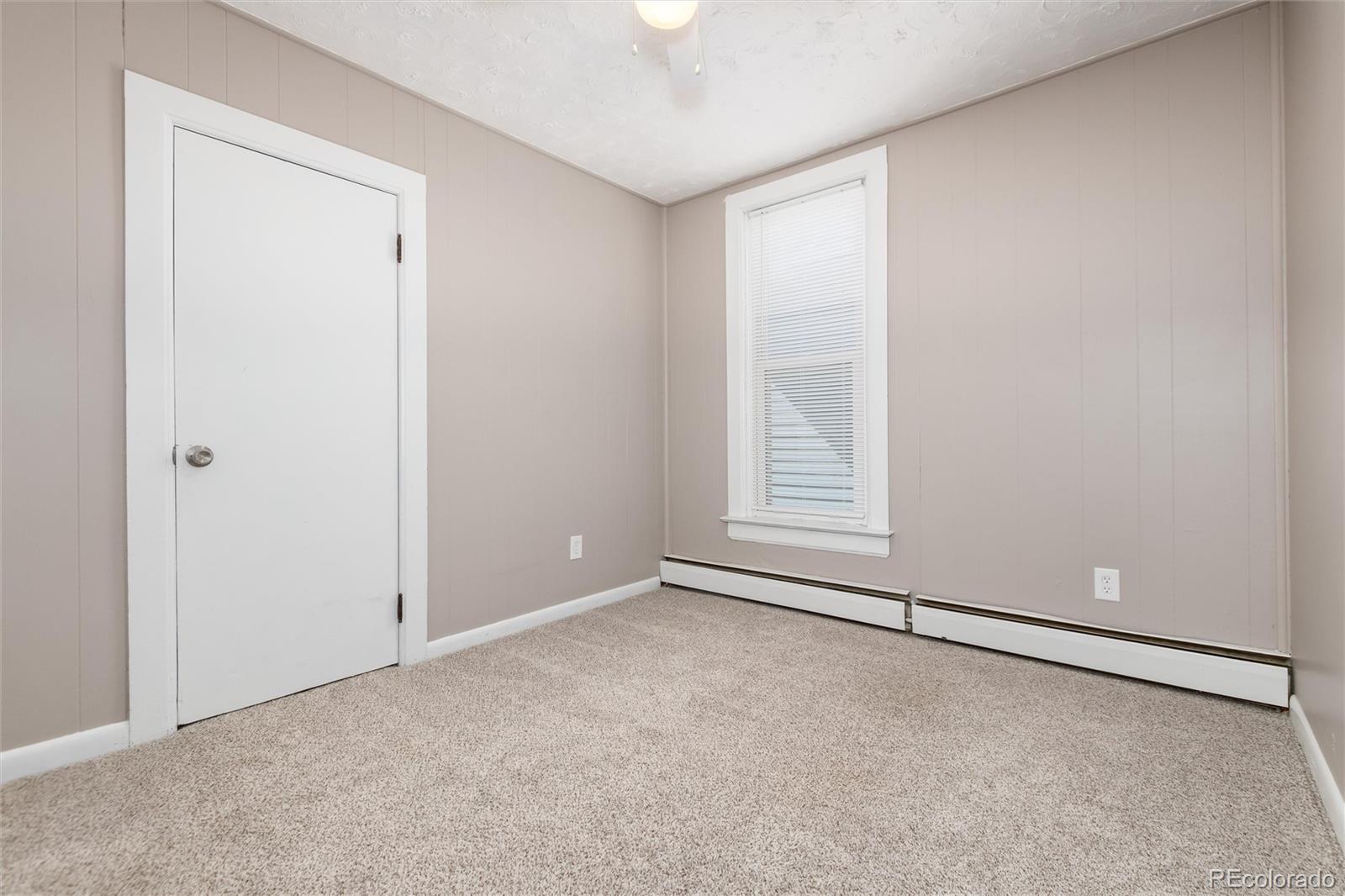 735 Colorado Boulevard Idaho Springs, CO 80452 - Photo 7 of 34 an empty room with windows and closet