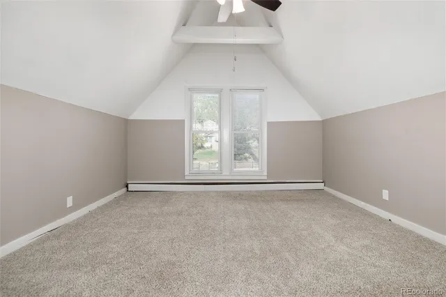 an empty room with chandelier fan