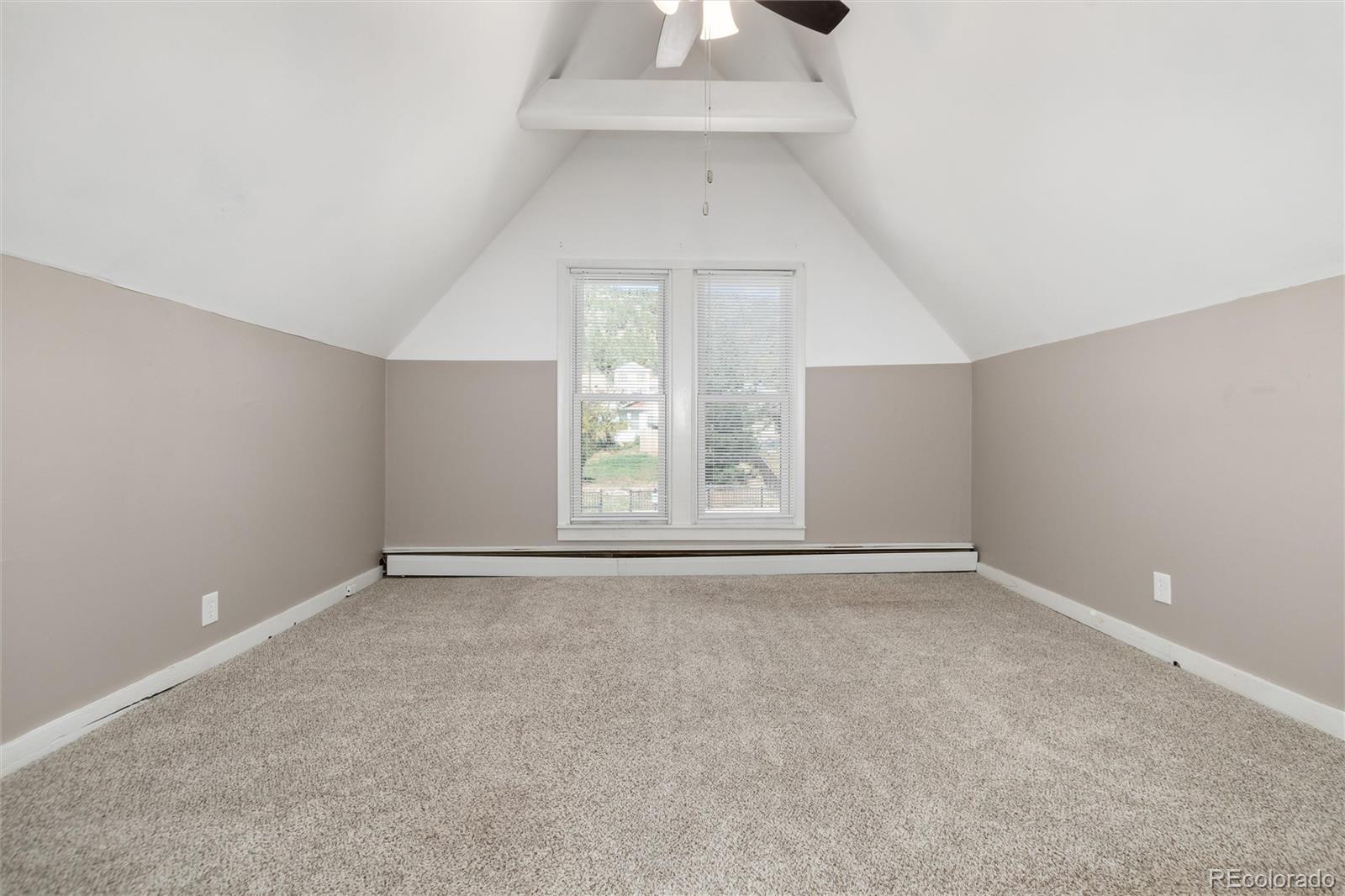 735 Colorado Boulevard Idaho Springs, CO 80452 - Photo 10 of 34 an empty room with windows and chandelier fan