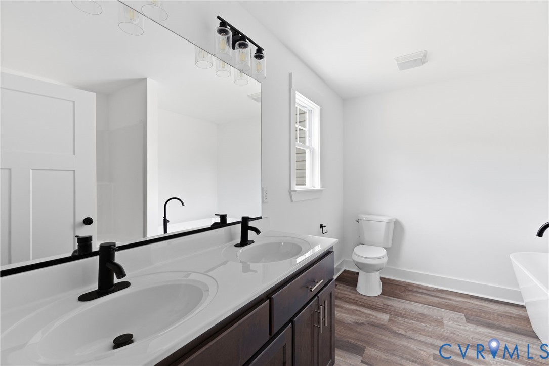5245 Courtland Road Disputanta, VA 23842 - Photo 15 of 27 a bathroom with a sink and a toilet