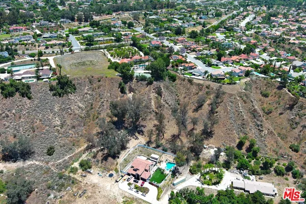 an aerial view of a houses with yard