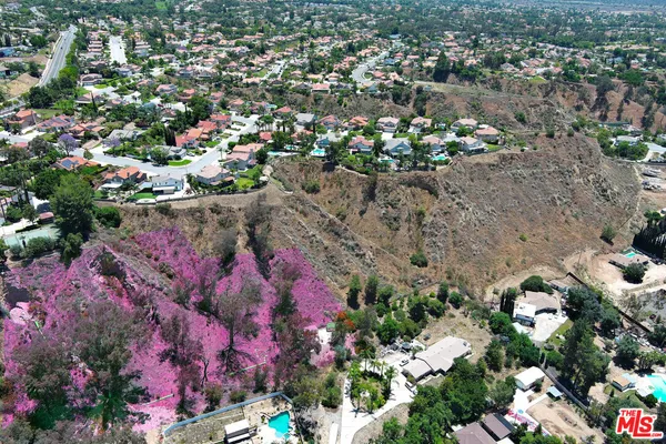 an aerial view of residential house with outdoor space and swimming pool