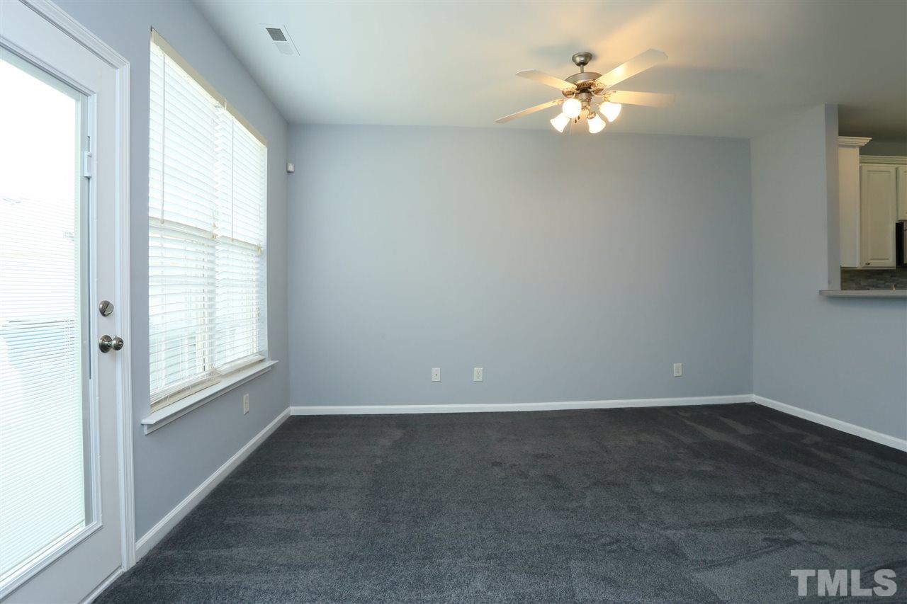 8454 Reedy Ridge Lane Raleigh, NC 27613 - Photo 11 of 30 an empty room with windows and chandelier fan