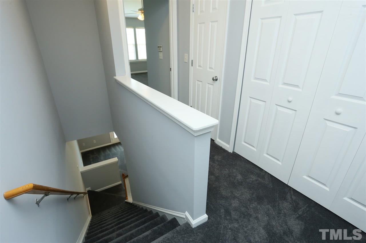 8454 Reedy Ridge Lane Raleigh, NC 27613 - Photo 16 of 30 a view of a hallway and wooden floor with a bathroom