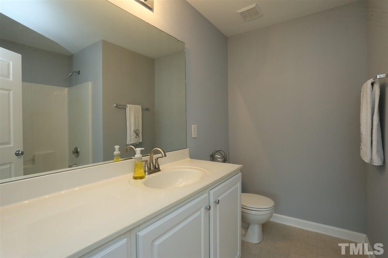 8454 Reedy Ridge Lane Raleigh, NC 27613 - Photo 19 of 30 a bathroom with a sink a toilet and shower