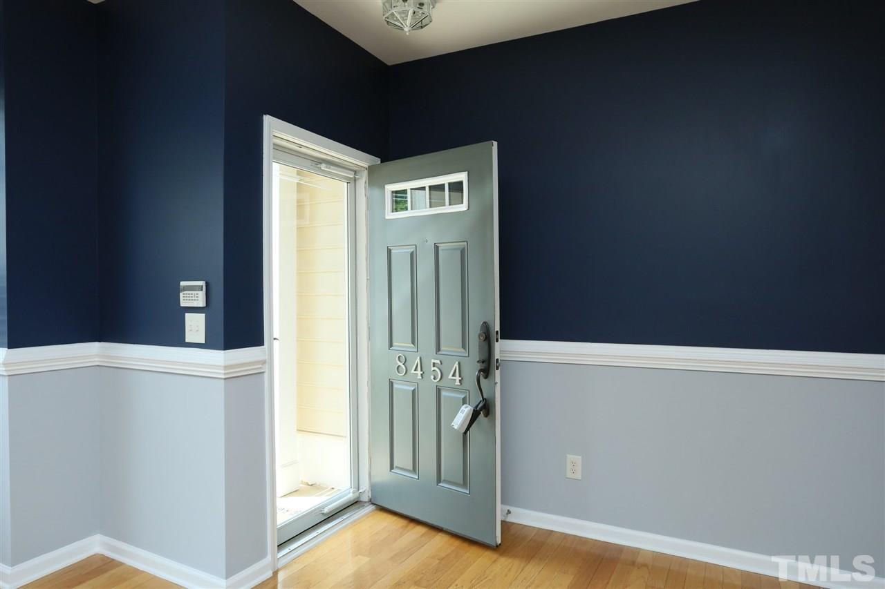 8454 Reedy Ridge Lane Raleigh, NC 27613 - Photo 3 of 30 a view of a hallway with wooden floor and staircase