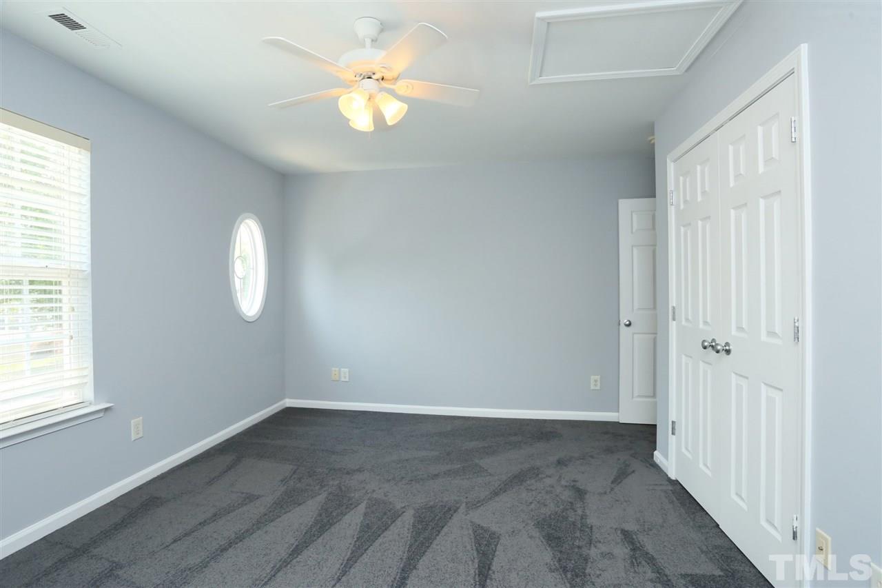 8454 Reedy Ridge Lane Raleigh, NC 27613 - Photo 21 of 30 an empty room with windows and chandelier fan
