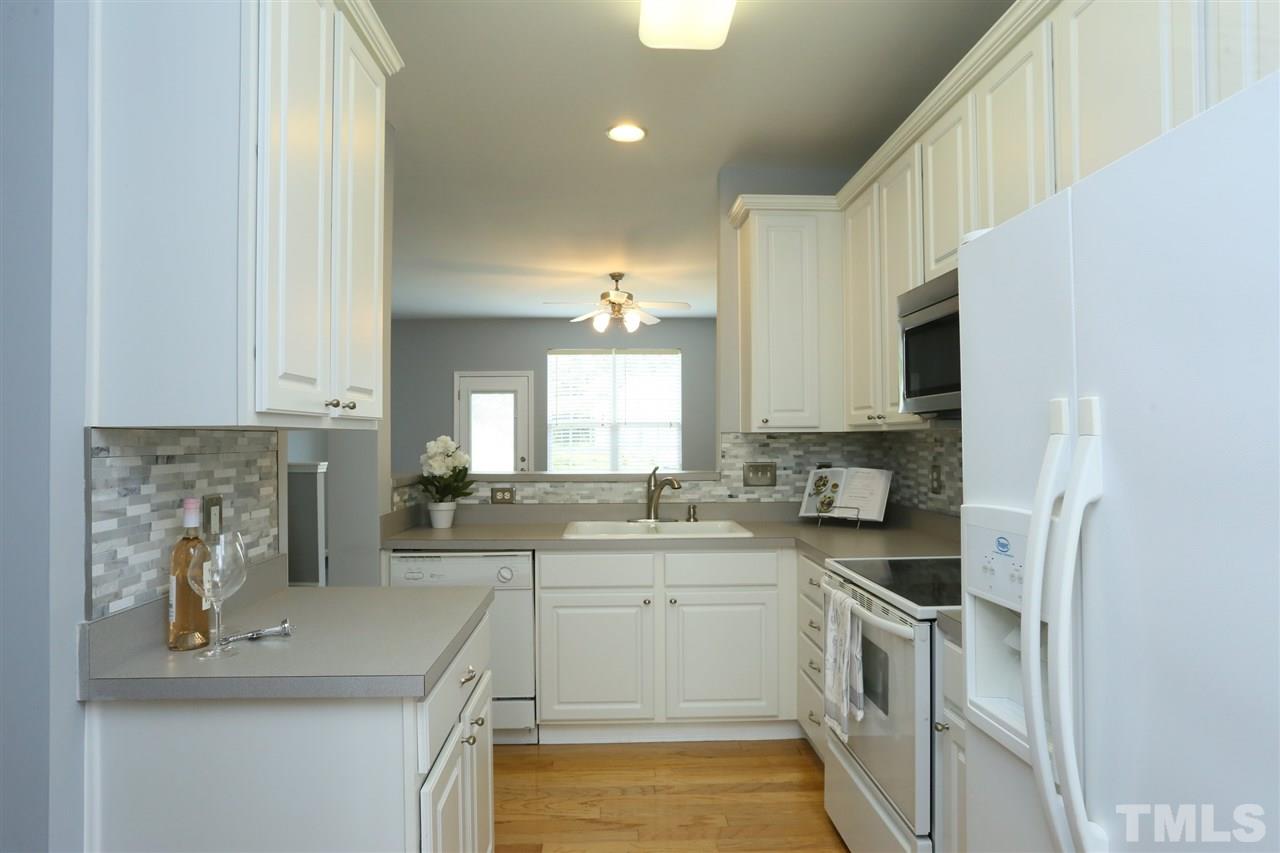 8454 Reedy Ridge Lane Raleigh, NC 27613 - Photo 6 of 30 a kitchen with a sink stove and cabinets