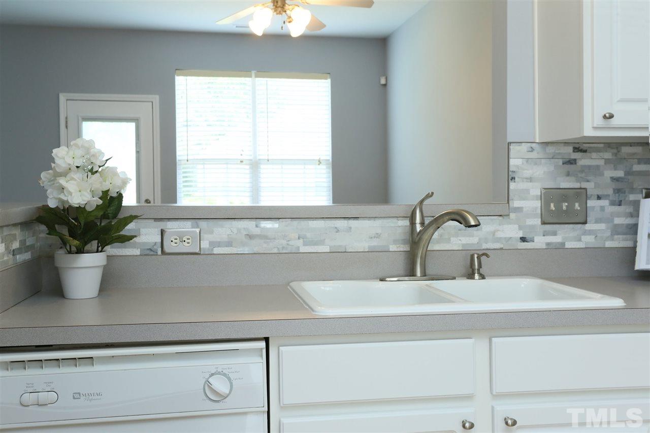 8454 Reedy Ridge Lane Raleigh, NC 27613 - Photo 9 of 30 a bathroom with a sink and a window