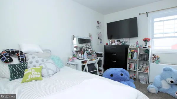 a bedroom with a bed and a flat tv screen