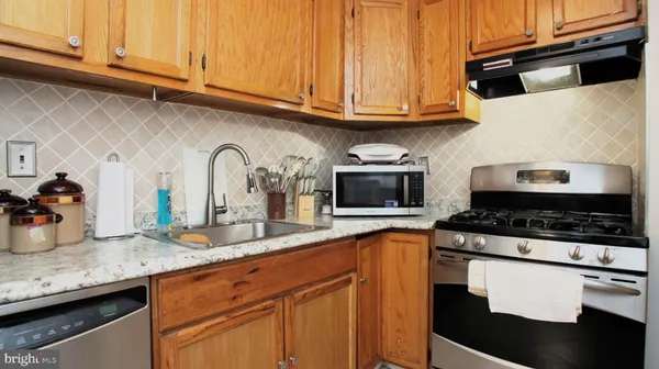 a kitchen with granite countertop cabinets and steel stainless steel appliances