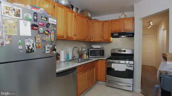 a kitchen with stainless steel appliances granite countertop a refrigerator sink and cabinets