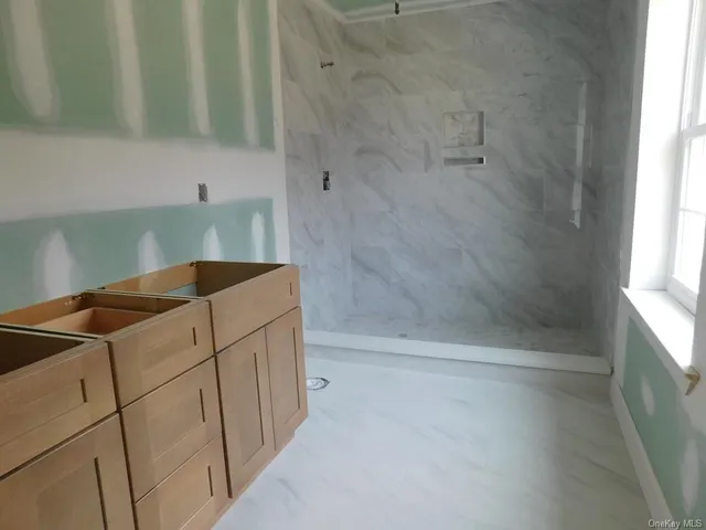 a bathroom with a bathtub and shower