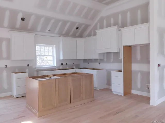 a kitchen with a sink cabinets and window