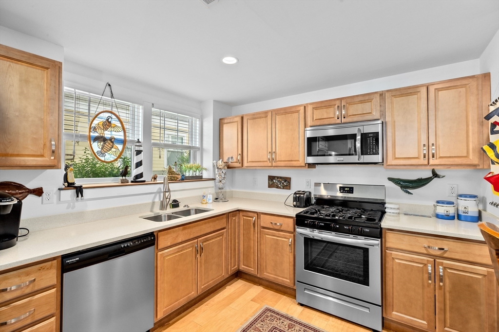 92 Marion Road, Unit LOWR Scituate, MA 02066 - Photo 5 of 18 a kitchen with a sink stove top oven and microwave