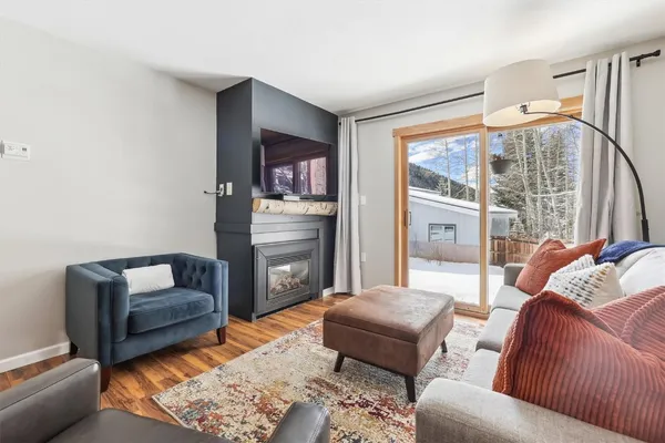 a living room with furniture and a floor to ceiling window