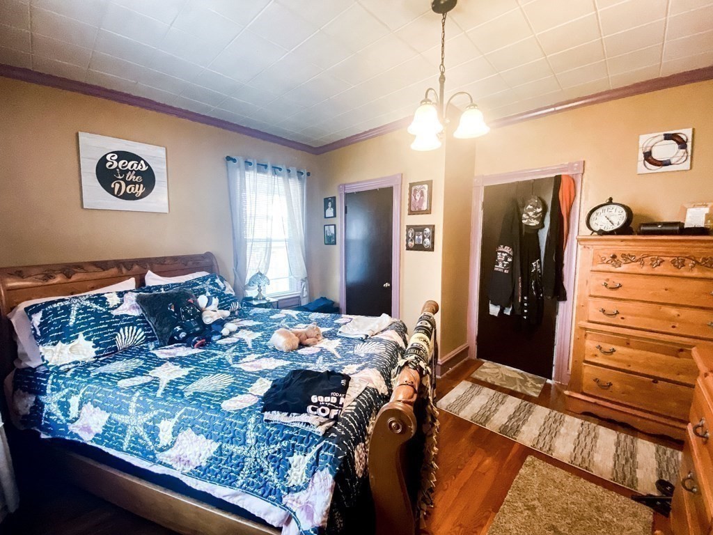 1141 Stafford Road Fall River, MA 02721 - Photo 11 of 30 a bed room with a bed mirror and a window