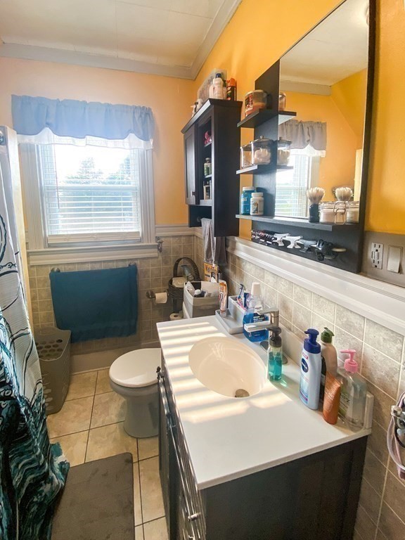 1141 Stafford Road Fall River, MA 02721 - Photo 13 of 30 a kitchen with a sink a stove and chairs
