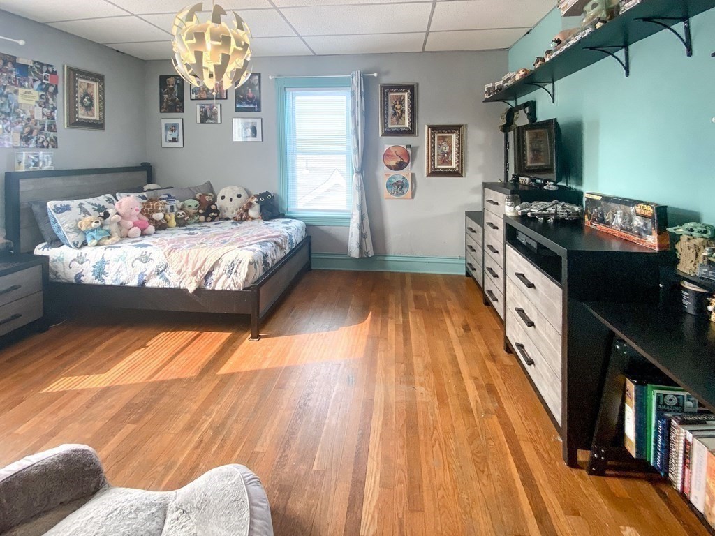 1141 Stafford Road Fall River, MA 02721 - Photo 17 of 30 a bedroom with a bed and wooden floor