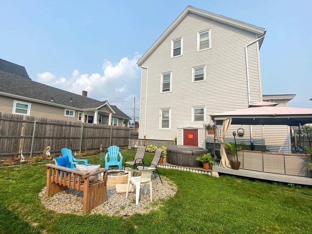 1141 Stafford Road Fall River, MA 02721 - Photo 24 of 30 a view of a house with backyard sitting area and garden