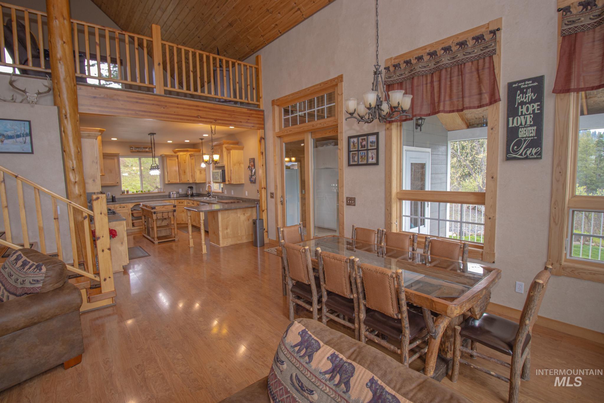237 Old Dent Road Orofino, ID 83544 - Photo 12 of 48 Dining space with hanging lights, dark wood-type flooring, and a high wood ceiling