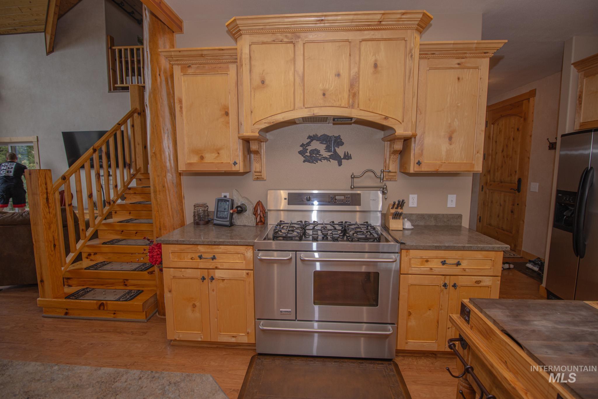 237 Old Dent Road Orofino, ID 83544 - Photo 15 of 48 Kitchen with stainless steel appliances, light wood finish cabinets, and light wood-type flooring