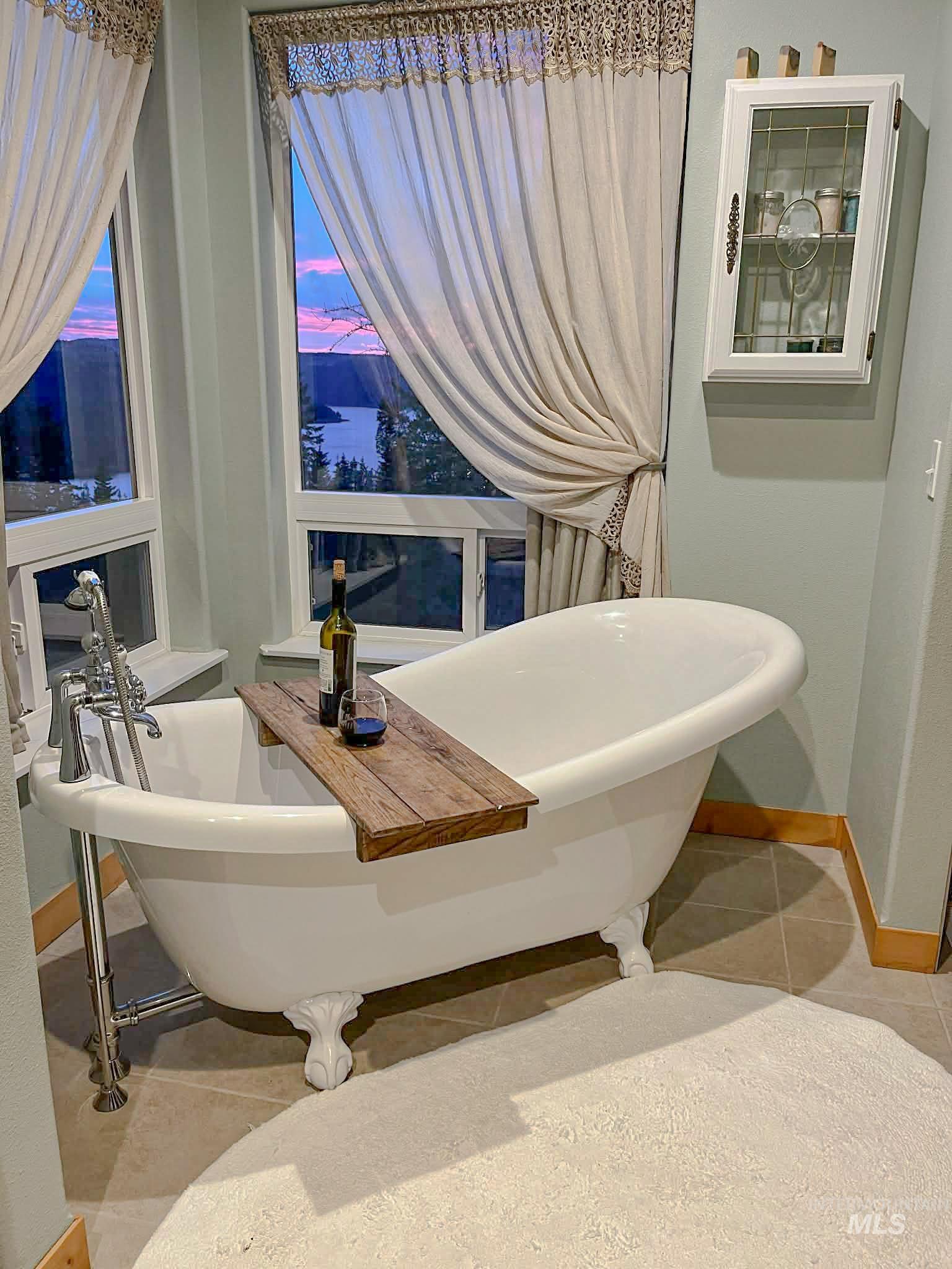 237 Old Dent Road Orofino, ID 83544 - Photo 18 of 48 Full bathroom featuring a freestanding tub and light tile patterned floors