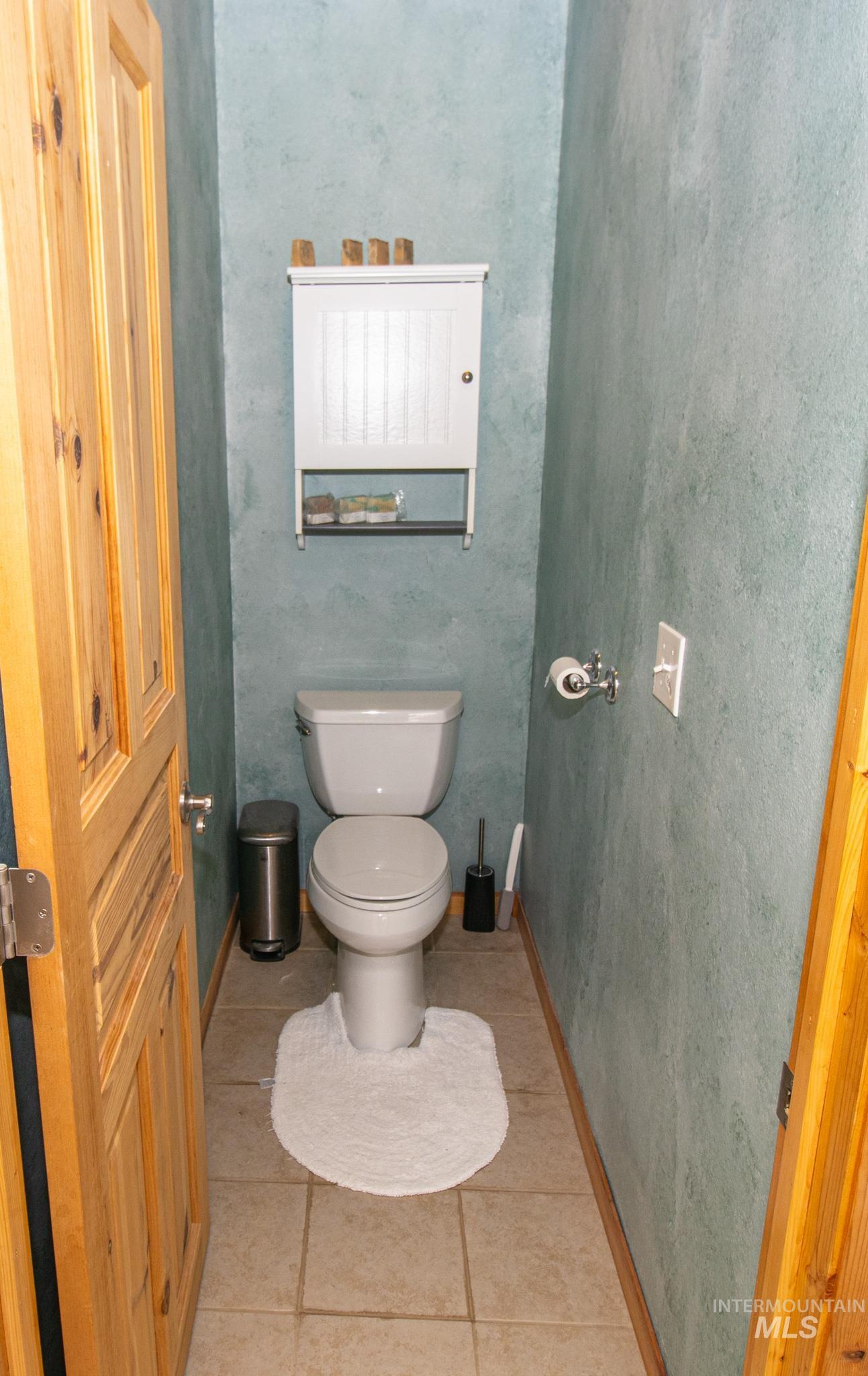 237 Old Dent Road Orofino, ID 83544 - Photo 22 of 48 Bathroom featuring toilet and light tile patterned floors