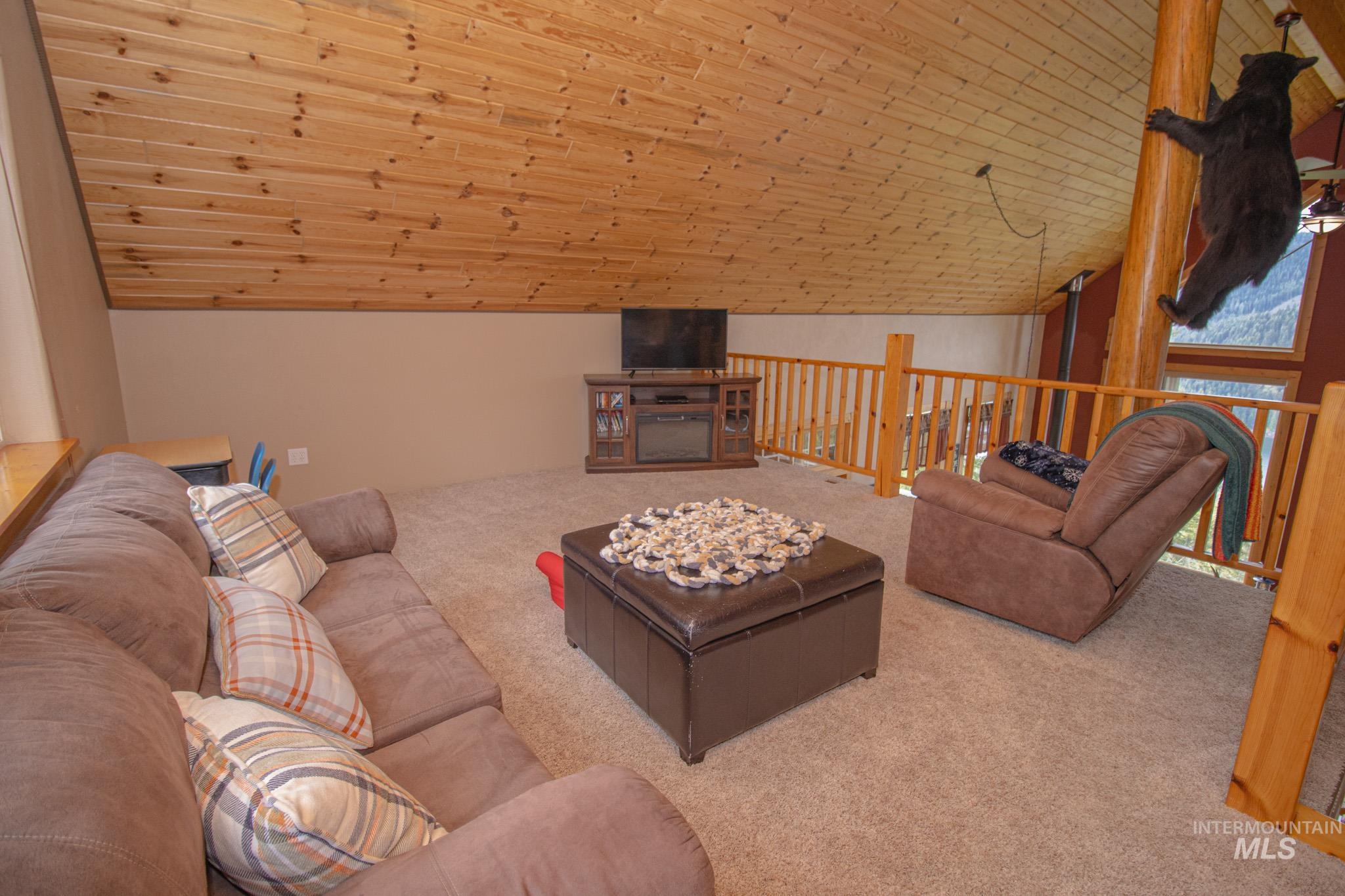 237 Old Dent Road Orofino, ID 83544 - Photo 27 of 48 Carpeted living room featuring a vaulted wood ceiling