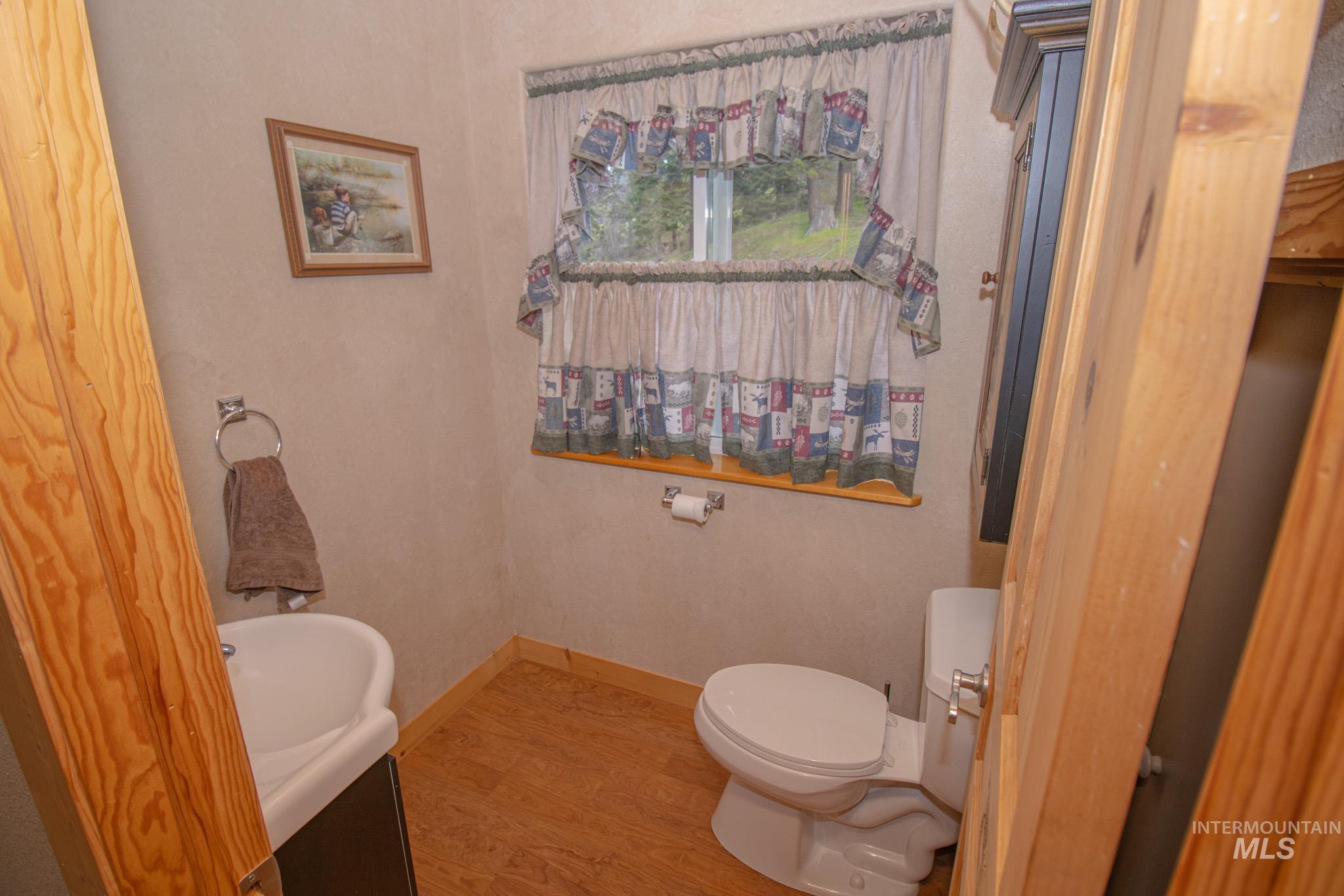 237 Old Dent Road Orofino, ID 83544 - Photo 28 of 48 Bathroom featuring baseboards and light wood-style floors