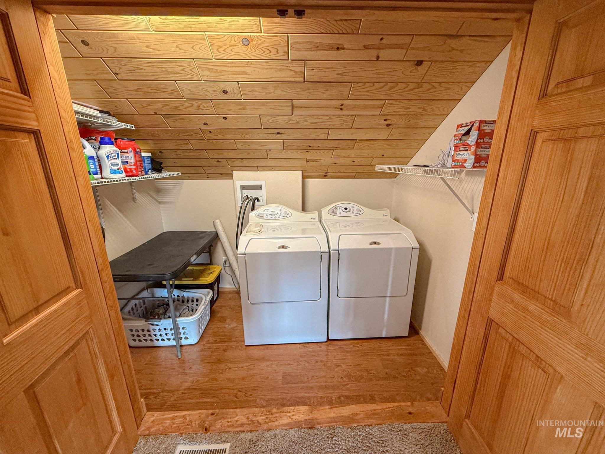 237 Old Dent Road Orofino, ID 83544 - Photo 29 of 48 Laundry room featuring wood ceiling, wood finished floors, and washer and clothes dryer