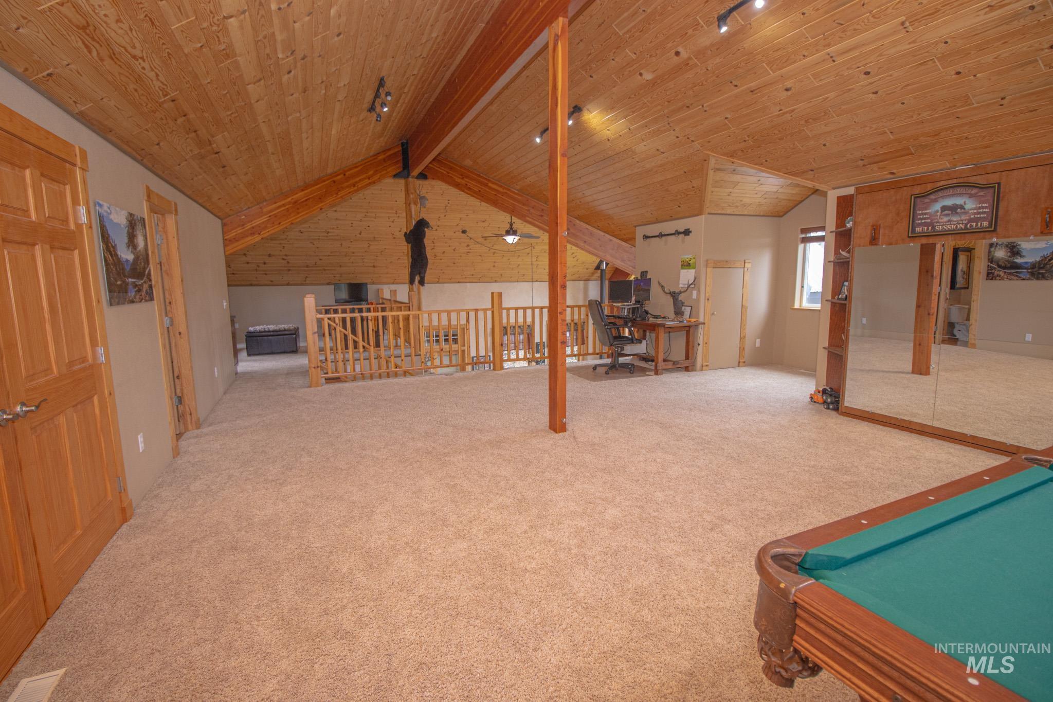 237 Old Dent Road Orofino, ID 83544 - Photo 30 of 48 Game room featuring a wooden ceiling with exposed beams, carpet, pool table, an office area, and brick wall
