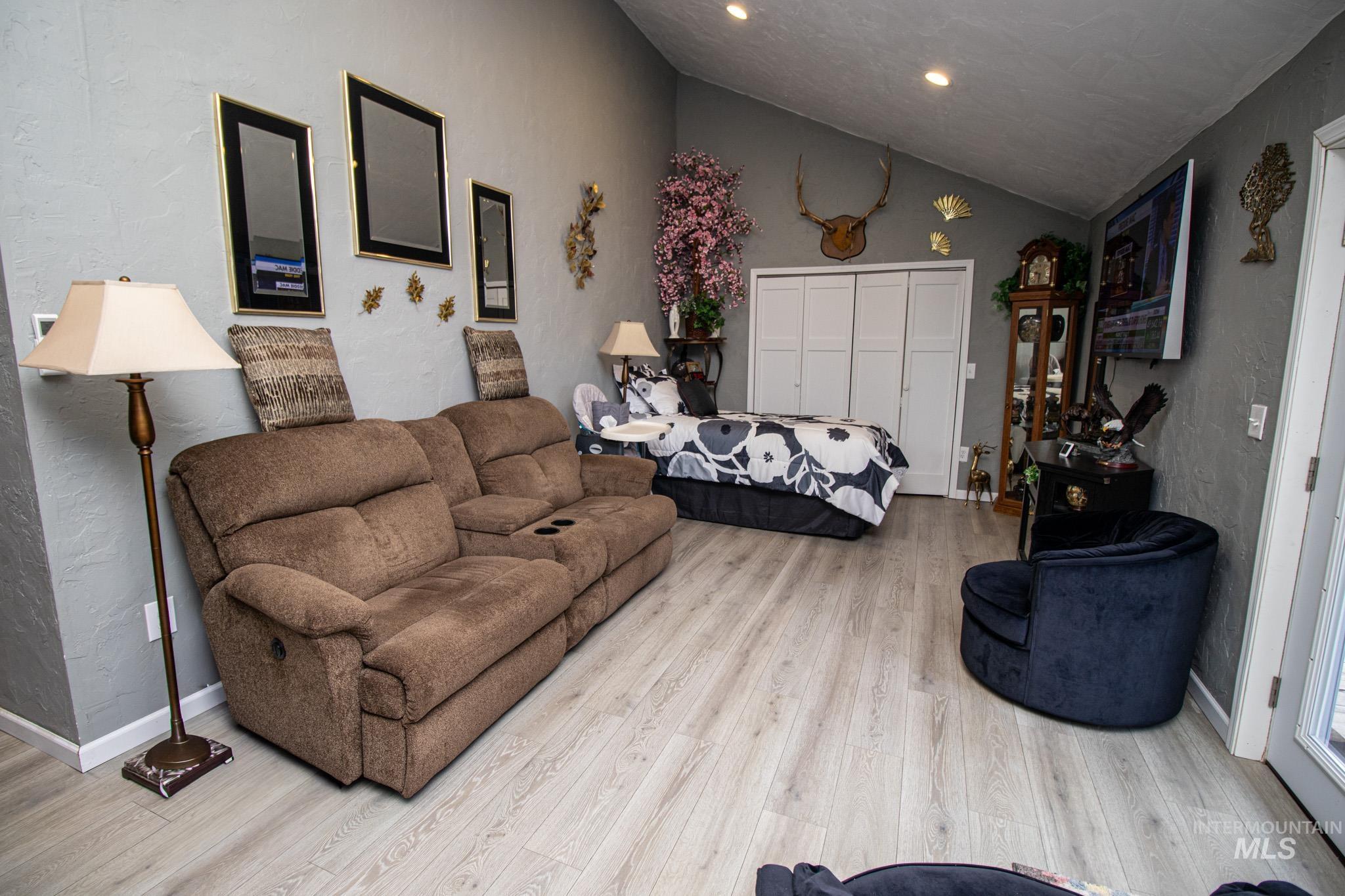 237 Old Dent Road Orofino, ID 83544 - Photo 34 of 48 Bedroom featuring a textured wall, vaulted ceiling, light wood-type flooring, a closet, and recessed lighting
