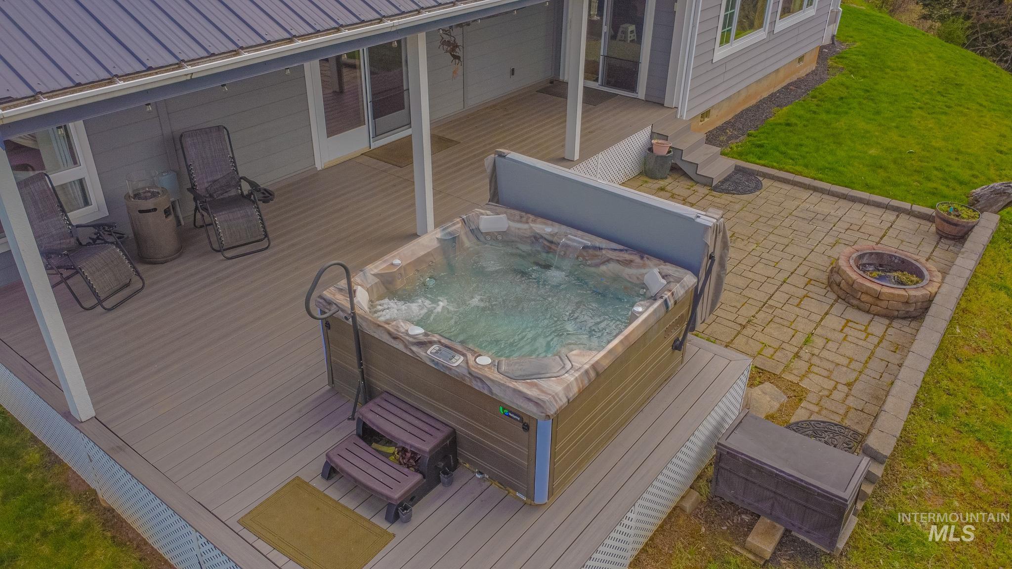 237 Old Dent Road Orofino, ID 83544 - Photo 5 of 48 Wooden deck featuring a lawn and a hot tub