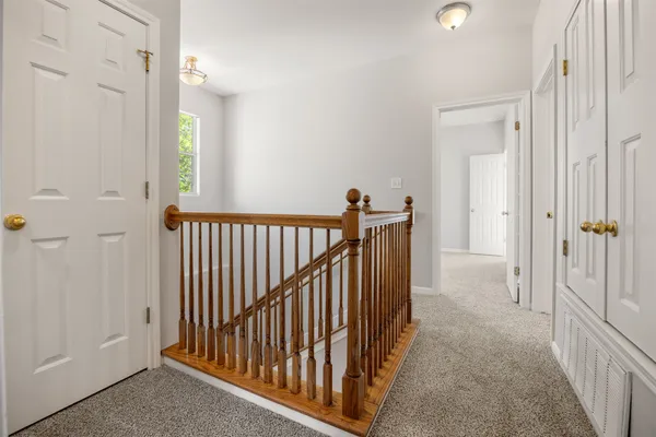 an empty room with closet and a ceiling fan