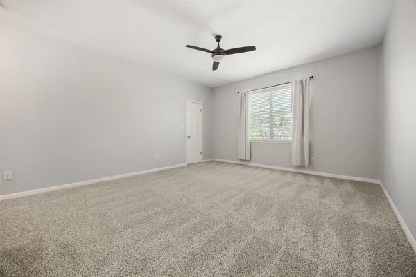 an empty room with windows and closet
