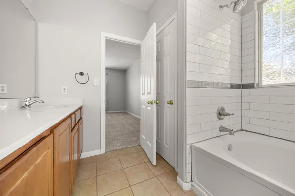 a bathroom with a sink a toilet and a large mirror