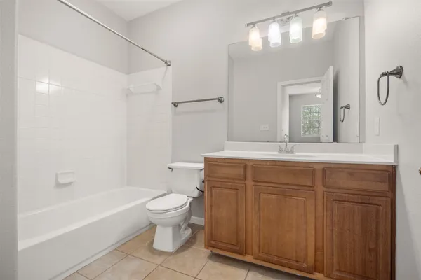 a kitchen with stainless steel appliances granite countertop a refrigerator a stove top oven a sink a dining table and chairs with wooden floor